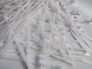 White plastic cable ties isolated on a white background