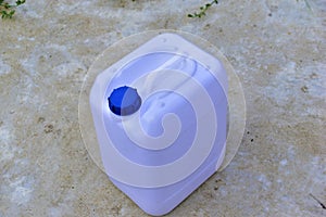 White plastic canister with blue lid in different positions