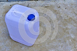 White plastic canister with blue lid in different positions