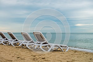 White plastic chairs on Black sea coast Zatoka Ukraine