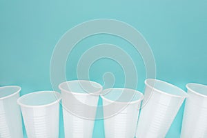 White plastic empty cups laid out in a row