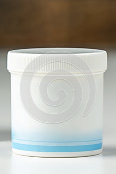 White plastic jar with cream, cosmetic product