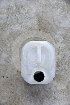 White plastic large canister. An empty plastic canister