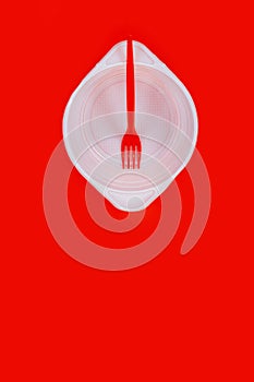 White plastic isolated empty plate fork red background cheap