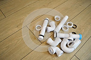 White plastic plumbing, plumbing pipes, smooth and curved, fittings, flanges, rubber gaskets