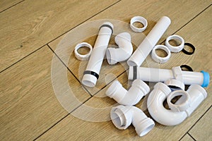 White plastic plumbing, plumbing pipes, smooth and curved, fittings, flanges, rubber gaskets