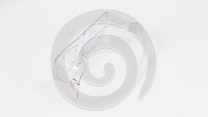 White plastic protective work glasses with rubber band.