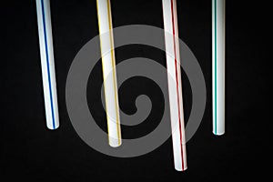 White plastic straws with colored stripes, polluting material