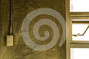 White plastic switch panel is on loft style wall