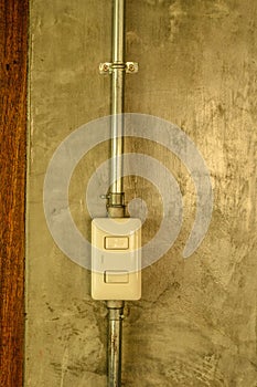 White plastic switch panel is on loft style wall