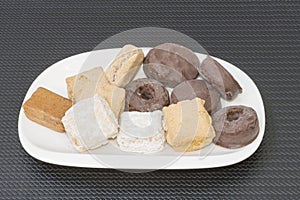 A white plate with assorted cakes