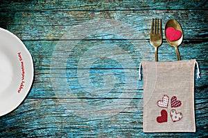 White plate and bag of spoon and fork with red heart