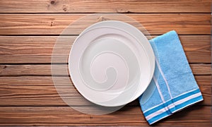 White Plate and Blue Napkin on Rustic Wooden Table