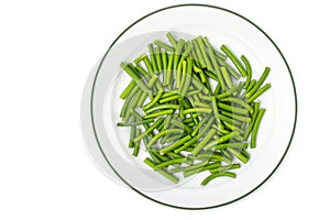 White plate with boiled green beans, top view