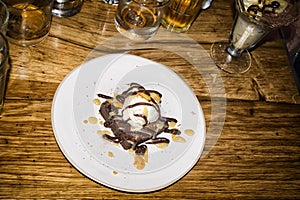 White plate with chocolate brownie ice cream dessert