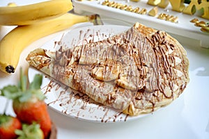 White Plate With Chocolate-covered Banana Split