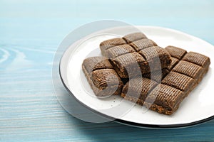 White plate with delicious and healthy hematogen on blue wooden table, closeup