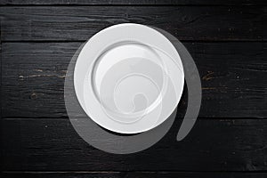 White plate empty utensil with copy space for text or food with copy space for text or food, top view flat lay  , on black wooden