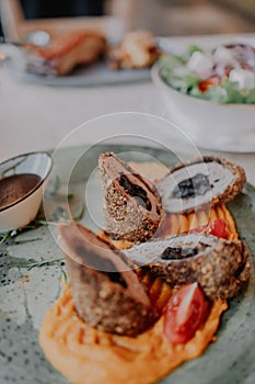 White plate filled with a variety of assorted bread rolls and healthy dish