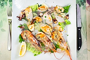 white plate with fried prawns and squids photo