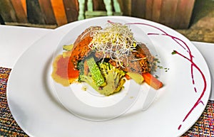 White plate with gourmet vegetarian dish meal in restaurant Mexico