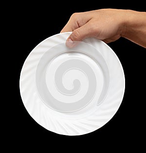 White plate in hand on a black