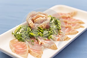 White plate with Japanese food on blue background