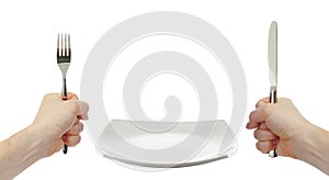 White plate, knife and fork cutlery in hands