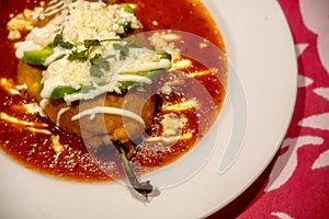 White plate with mexican stuffed chili chile relleno and copyspace