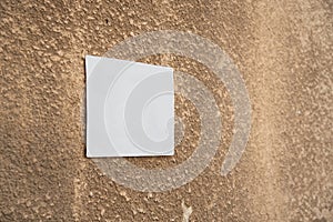 White plate mockup on an orange cement wall