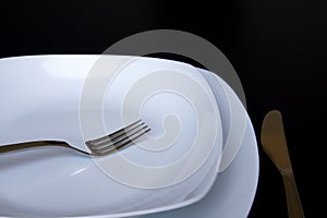 A white plate with silver fork