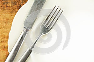 White Plate and Silverware on wood Table