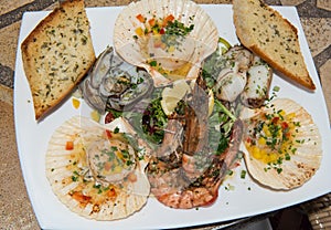 White plate with spread seafood with spices