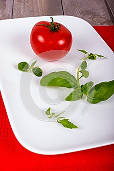 White plate with tomato and spices