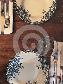 White plates decorated with flowers and plants in blue color
