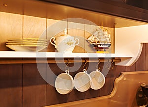 White plates and dinnerware in a cupboard