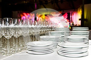 White plates and stemware glass at photo