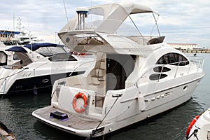 White pleasure yacht with a canvas awning