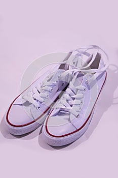 White plimsolls stand on a white background