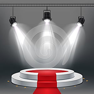 White podium and red carpet illuminated by spotlights