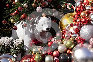 White polar bear, Christmas tree decorated with bright balls, cyclamen persicum plants at the flower shop in Athens