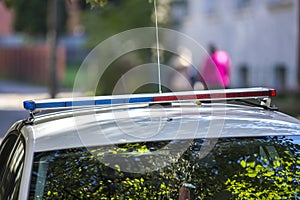 White police car cruiser with emergency lights parked on sunny summer street. Security and control in modern life