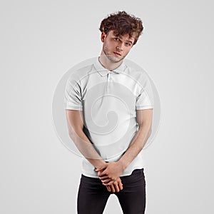 White polo mockup on young man in black jeans, front view, isolated on background
