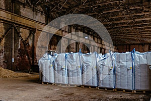 White polyethylene bags with factory products in warehouse