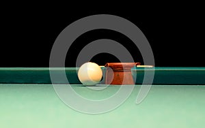 White Pool Ball on Billiard Table Near the Hole