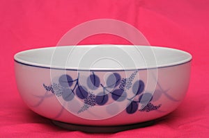 A white porcelain bowl with blue leaves printings