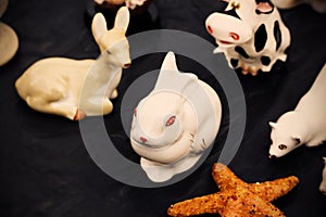 White porcelain bunny with red eyes surronded by other soviet figurines