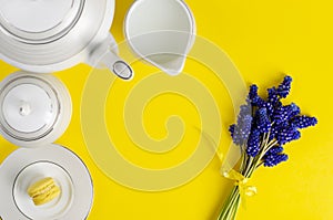 White porcelain coffe or tea set with muscari flowers on yellow