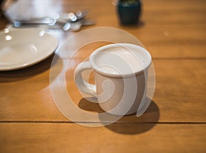 White porcelain cup with chai latte tea