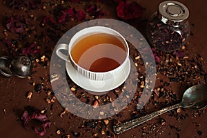 White porcelain mug on a saucer with herbal tea